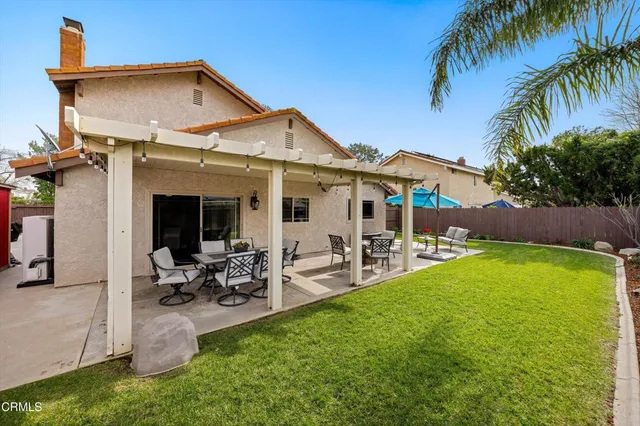 a front view of house with yard and outdoor seating