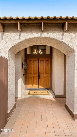 a view of a house with a door and a yard