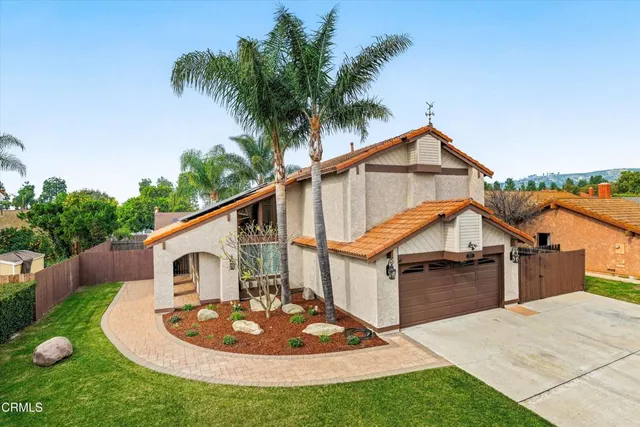 a view of a house with a sink and table in the patio