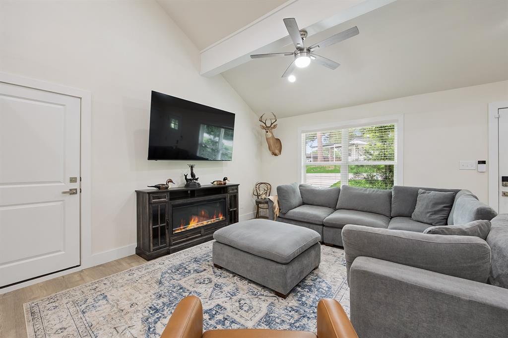 114 Ricky Road Gun Barrel City, TX 75156 - Photo 6 of 18 Spacious living area featuring a vaulted ceiling with exposed beam, an integrated ceiling fan, and wood-finish flooring