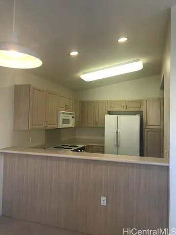 a view of kitchen with cabinets