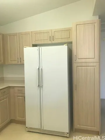 a white refrigerator freezer sitting inside of a kitchen
