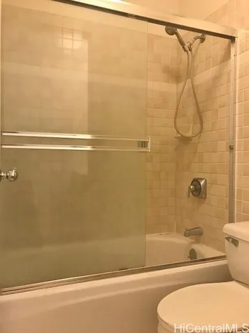 a bathroom with a shower and a toilet