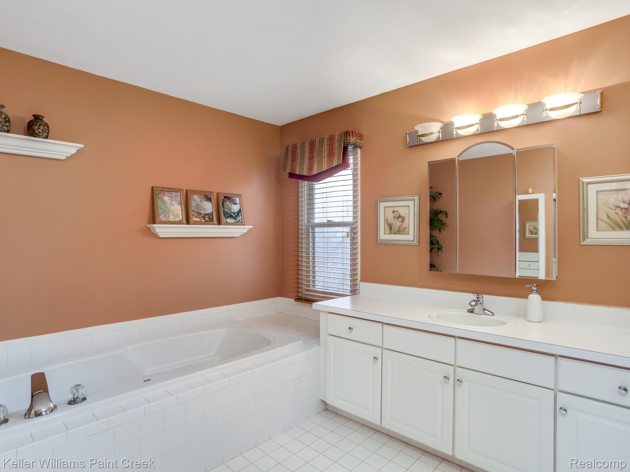 673 Lake Ridge Road Rochester, MI 48307 - Photo 15 of 26 The master bathroom, with a large soaking tub and a very large vanity counter space.