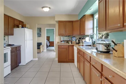 a kitchen with stainless steel appliances a stove a sink and a refrigerator