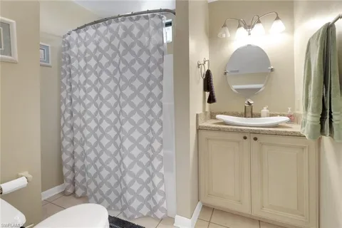 an aerial view of a house with table and chairs under an umbrella