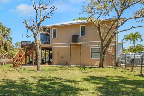 an aerial view of a house with yard table and chairs