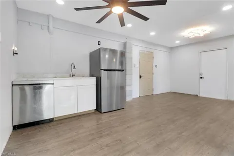 a view of an empty room with a kitchen