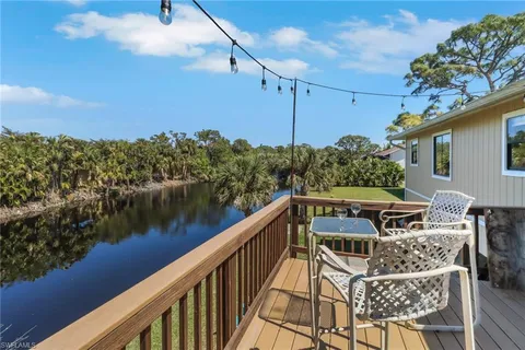 a view of a balcony with wooden floor and fence