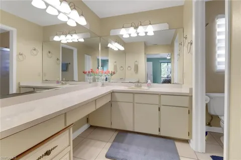 a bed sitting in a room next to a window