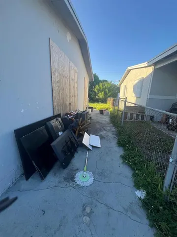 a backyard of a house with table and chairs