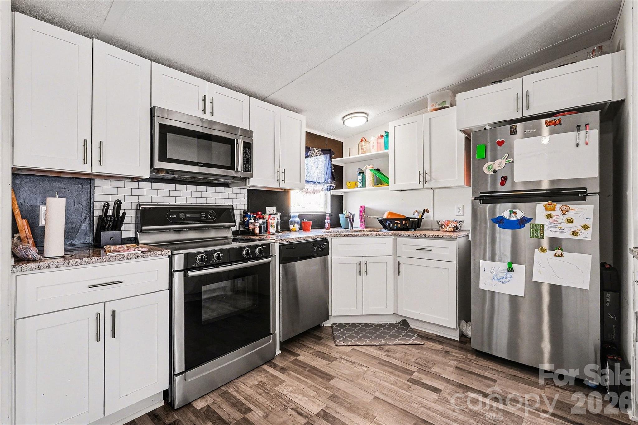 4106 Olga Court Dallas, NC 28034 - Photo 11 of 30 a kitchen with stainless steel appliances granite countertop a refrigerator stove and sink