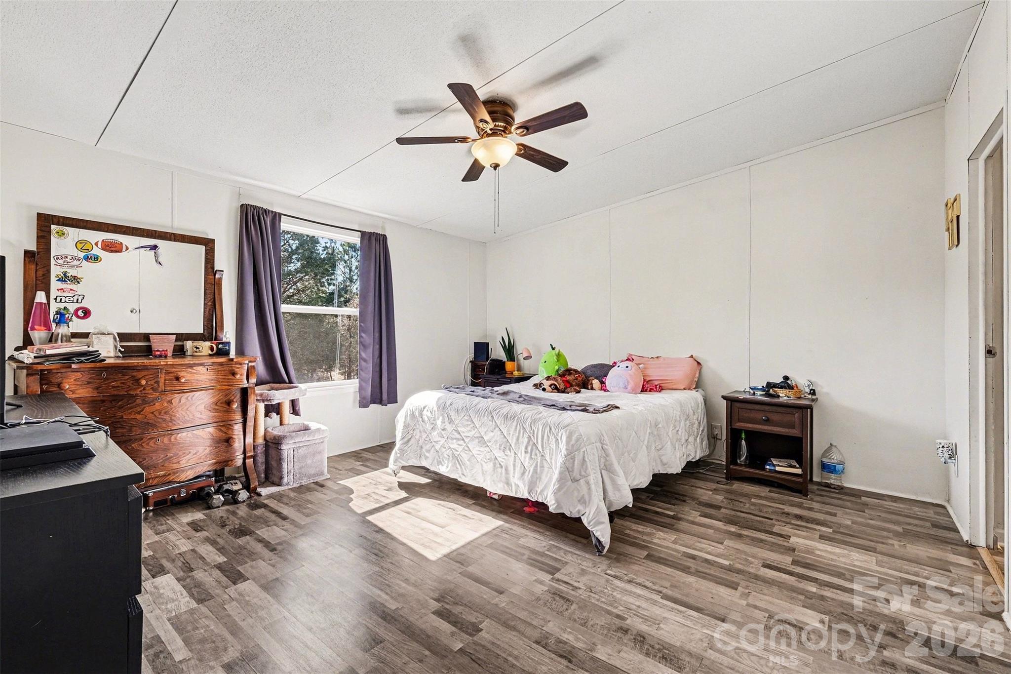 4106 Olga Court Dallas, NC 28034 - Photo 16 of 30 a bed room with a bed and a chandelier