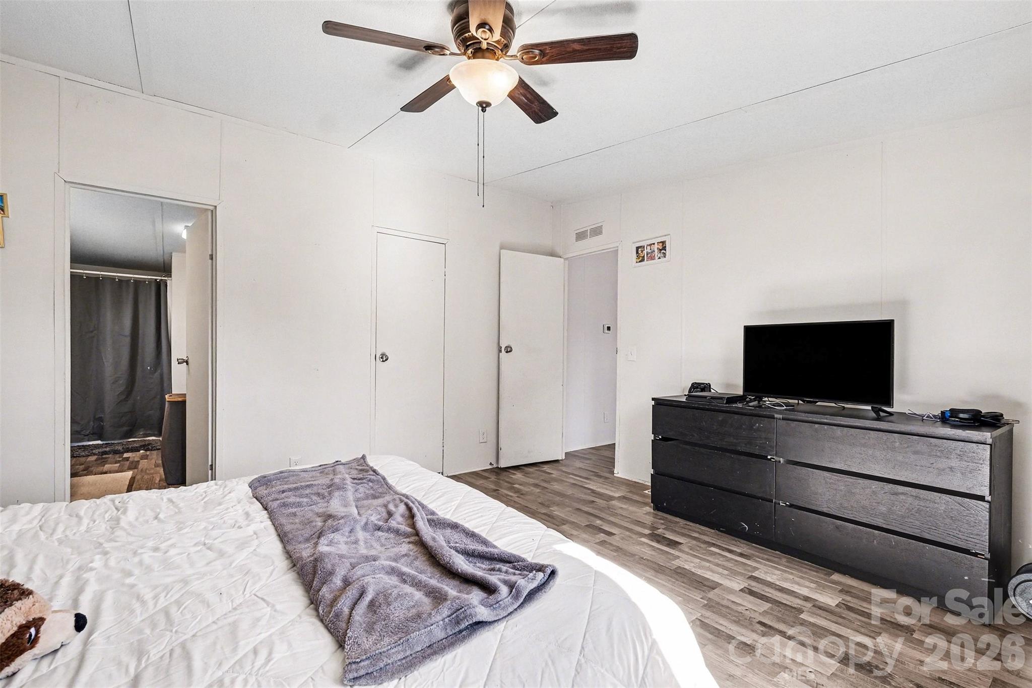4106 Olga Court Dallas, NC 28034 - Photo 18 of 30 a bedroom with a bed and a flat screen tv