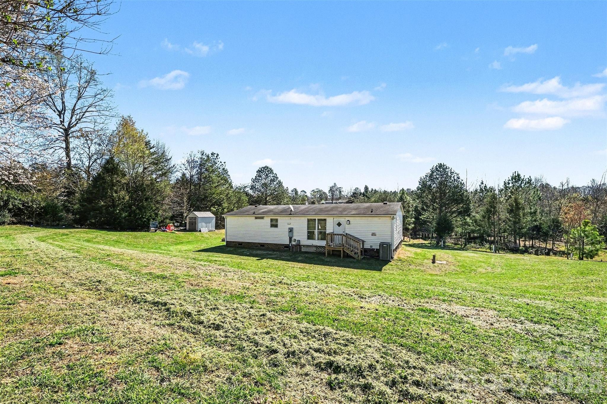 4106 Olga Court Dallas, NC 28034 - Photo 27 of 30 a view of a big yard with a large trees