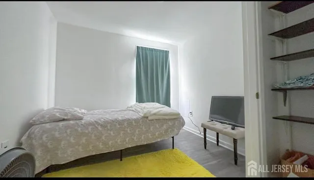 a bedroom with a bed and flat screen tv