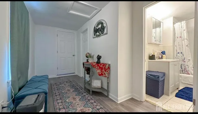 a view of a hallway with workspace and living room