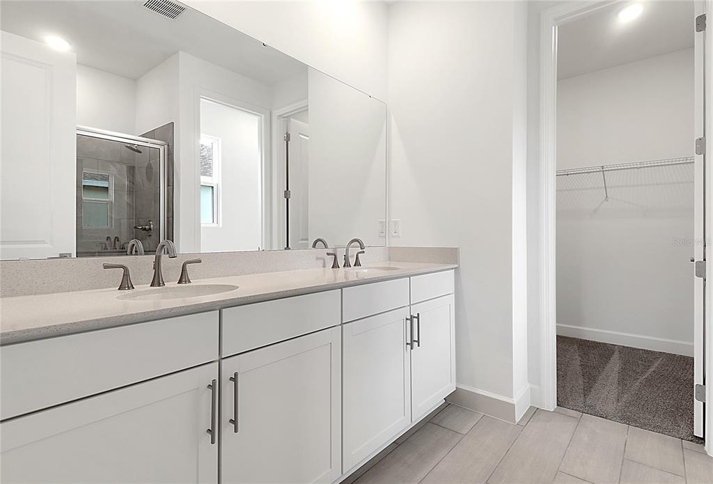 3723 Malad Way Tavares, FL 32778 - Photo 15 of 24 a bathroom with a double vanity sink mirror and cabinets