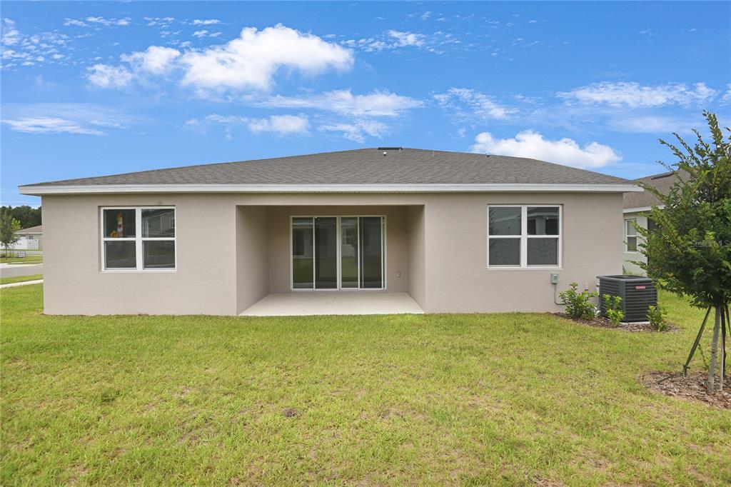 3723 Malad Way Tavares, FL 32778 - Photo 20 of 24 a view of a house with a backyard