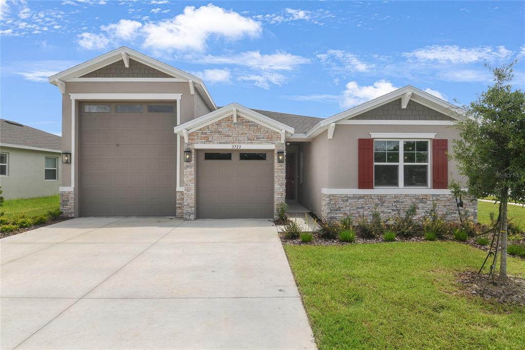 3723 Malad Way Tavares, FL 32778 - Photo 2 of 24 a front view of a house with a yard