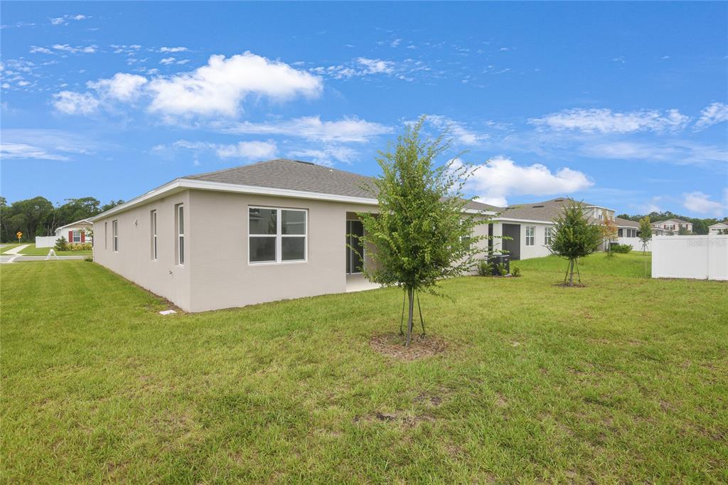 3723 Malad Way Tavares, FL 32778 - Photo 4 of 24 a view of a house with backyard and garden