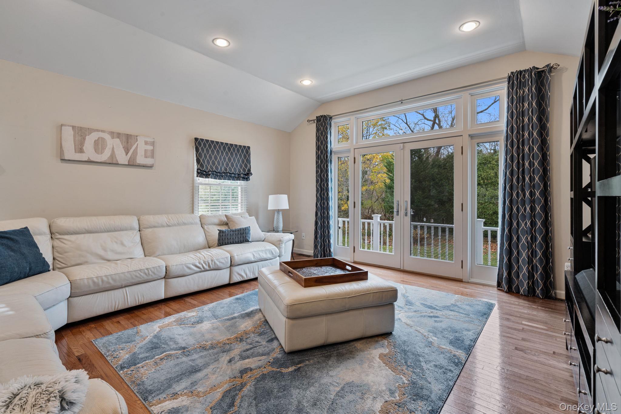 6 Daniel Way Setauket, NY 11733 - Photo 20 of 41 a living room with furniture and a floor to ceiling window