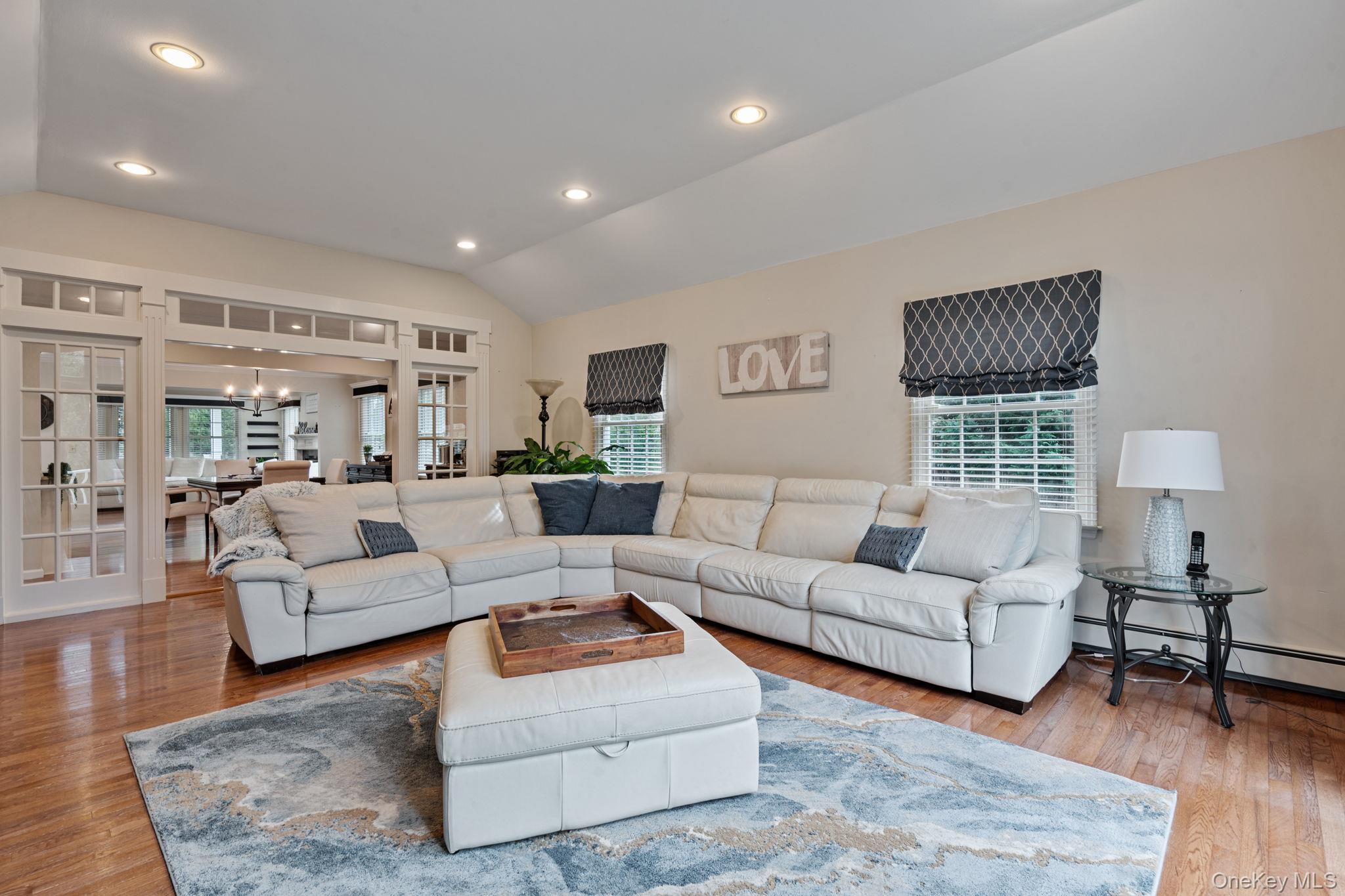 6 Daniel Way Setauket, NY 11733 - Photo 22 of 41 a living room with furniture and a wooden floor