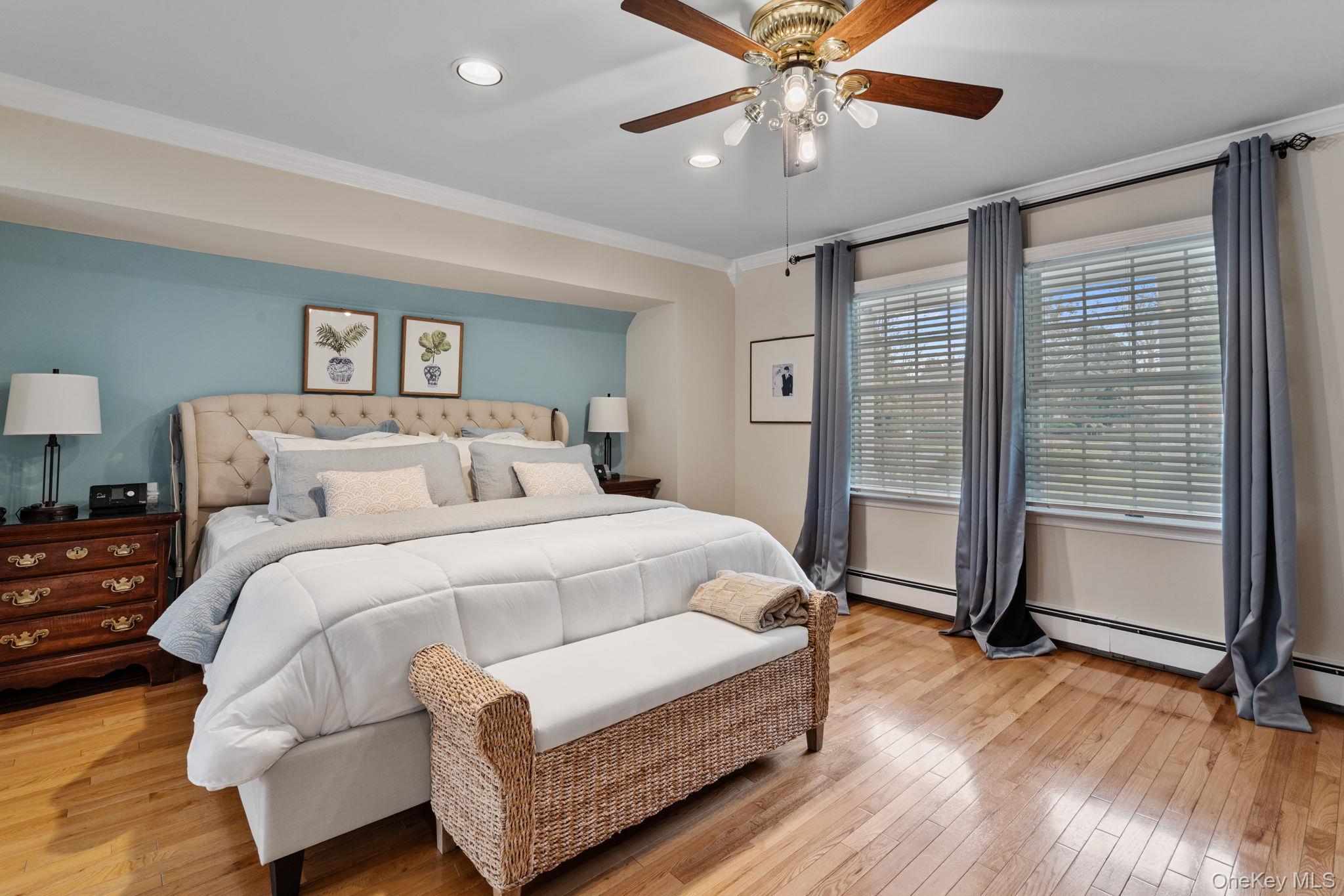 6 Daniel Way Setauket, NY 11733 - Photo 26 of 41 a spacious bedroom with a bed and a chandelier