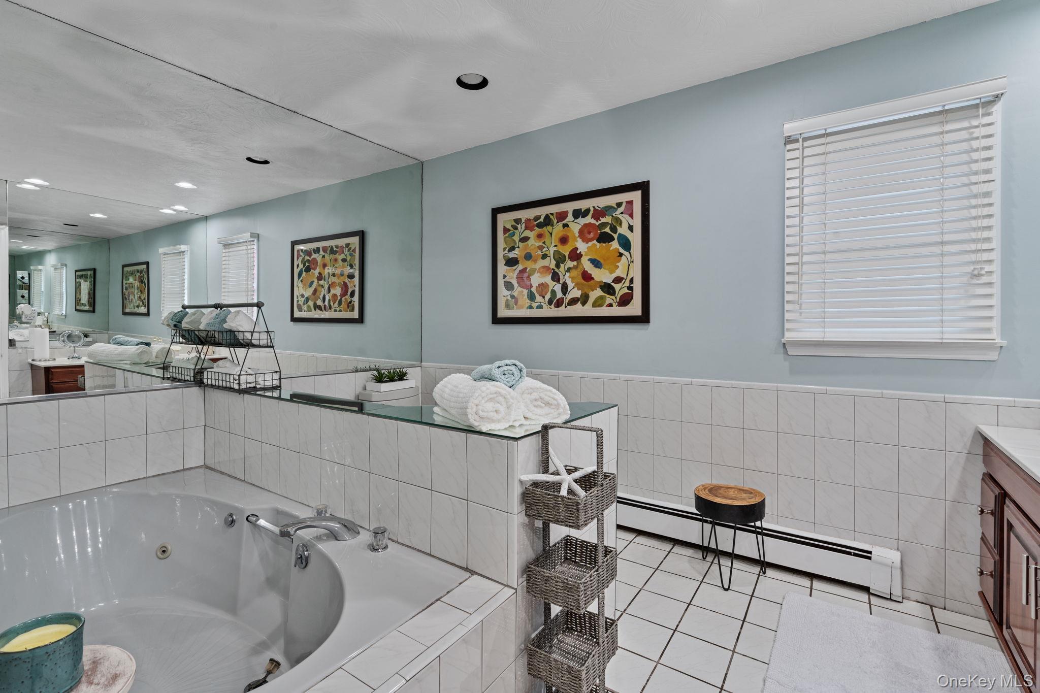 6 Daniel Way Setauket, NY 11733 - Photo 29 of 41 a bathroom with a sink mirror and a bathtub