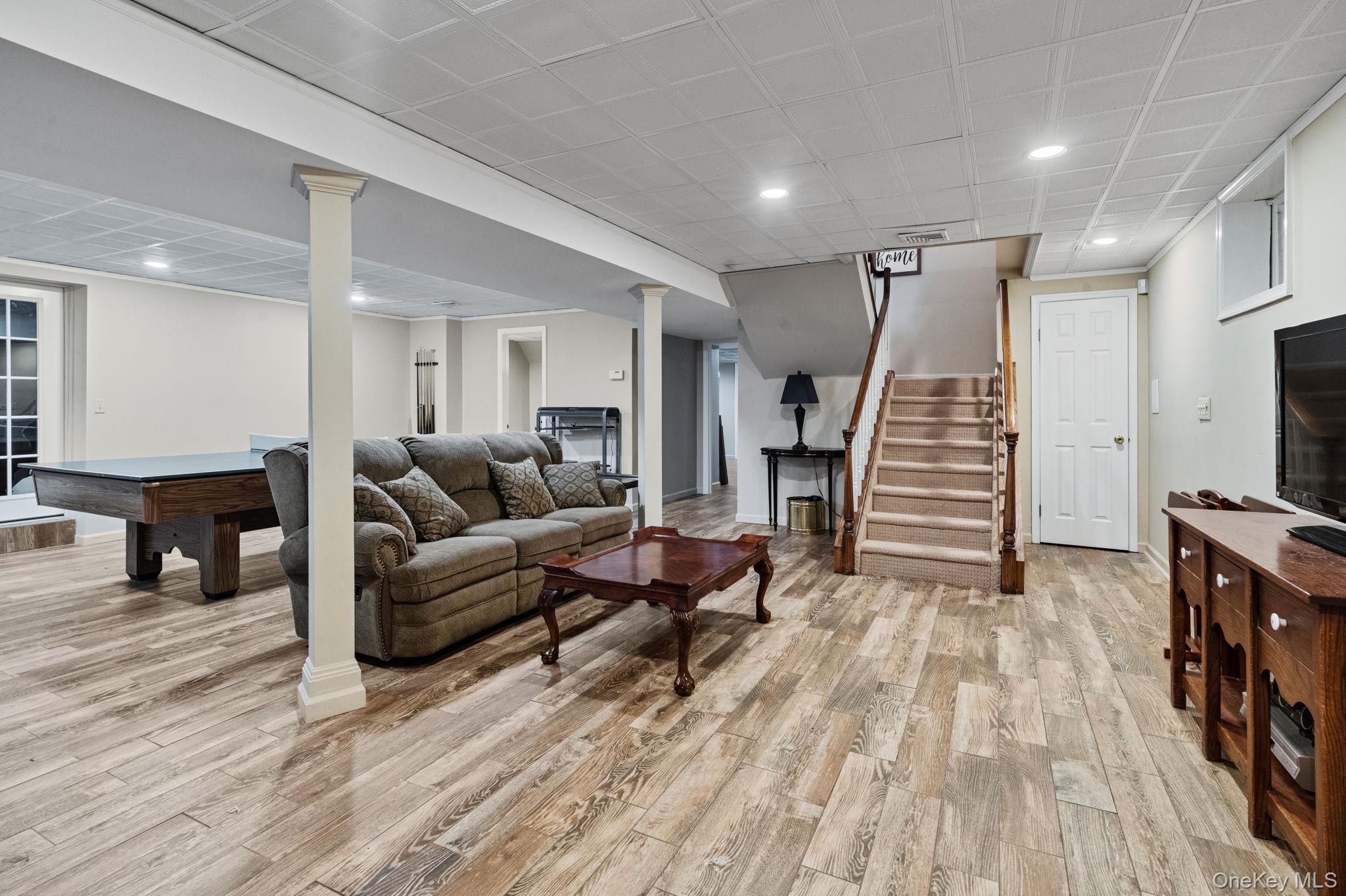 6 Daniel Way Setauket, NY 11733 - Photo 36 of 41 Living room featuring recessed lighting, stairs, light wood-style floors, and pool table