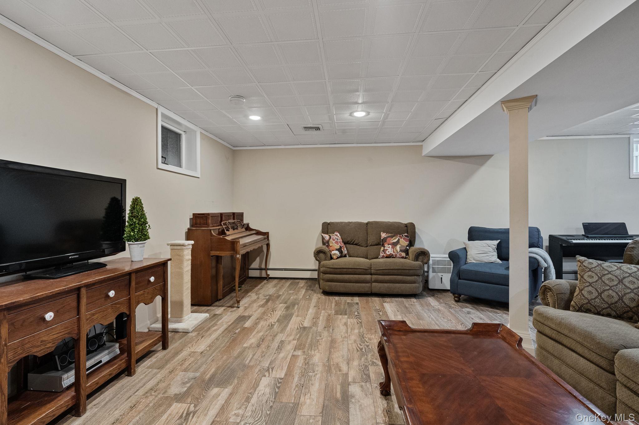 6 Daniel Way Setauket, NY 11733 - Photo 37 of 41 a living room with furniture and a flat screen tv