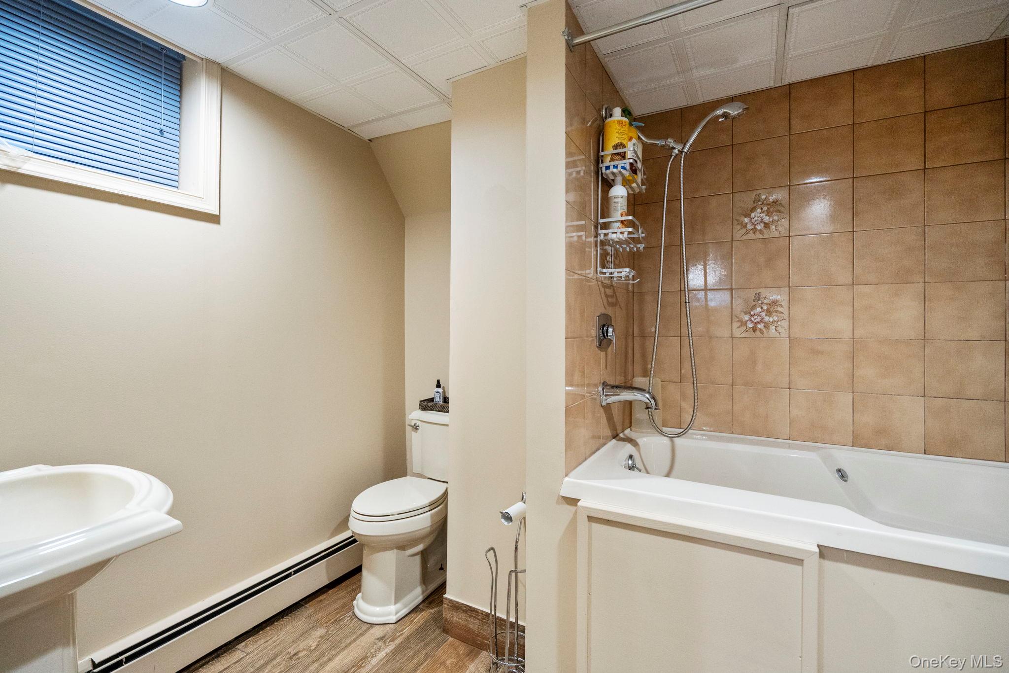 6 Daniel Way Setauket, NY 11733 - Photo 38 of 41 a bathroom with a sink a toilet and shower