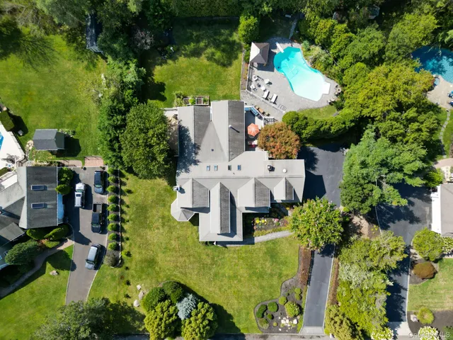 an aerial view of a house with yard swimming pool and outdoor seating