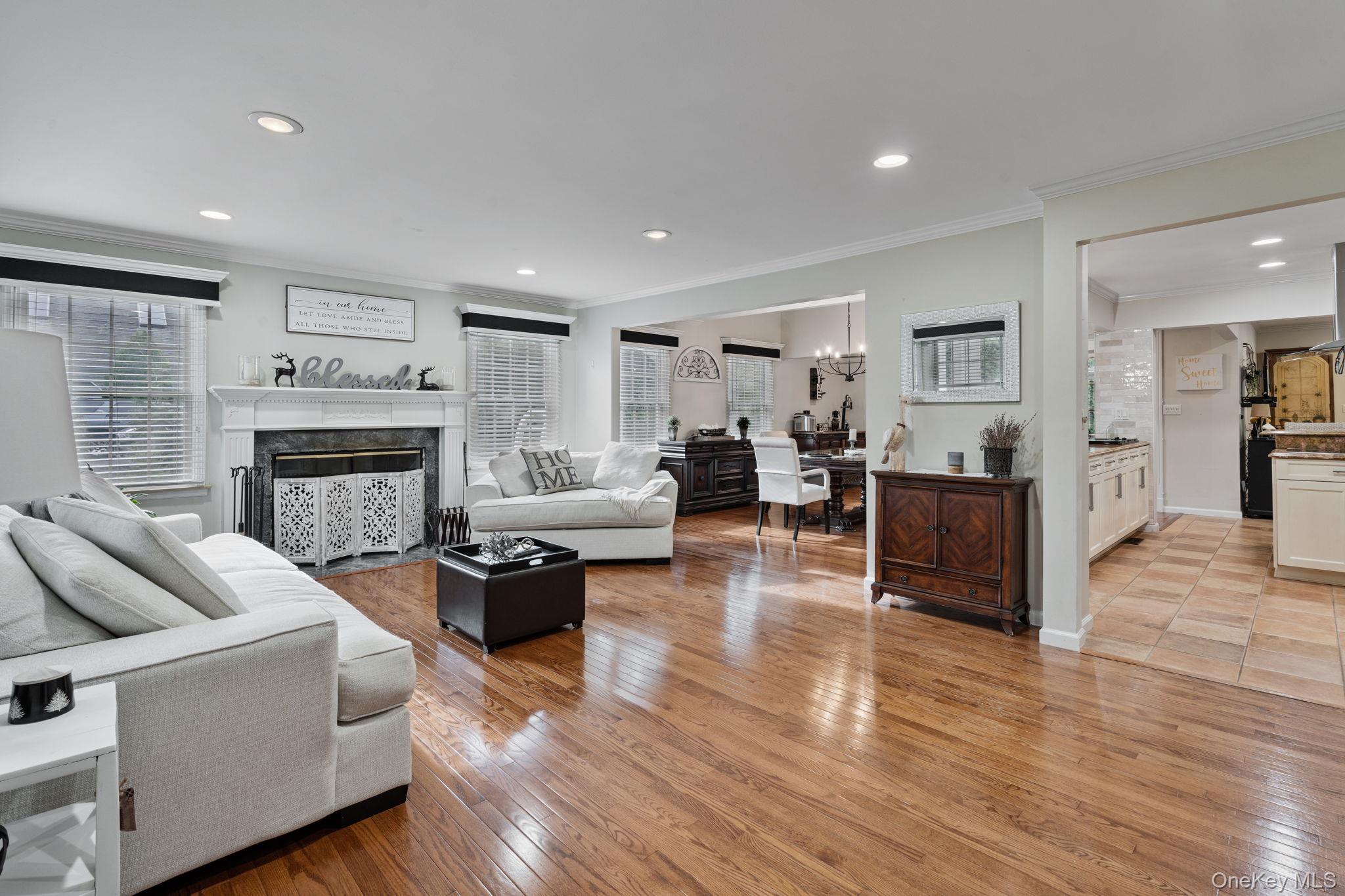 6 Daniel Way Setauket, NY 11733 - Photo 7 of 41 a living room with furniture wooden floor and a fireplace