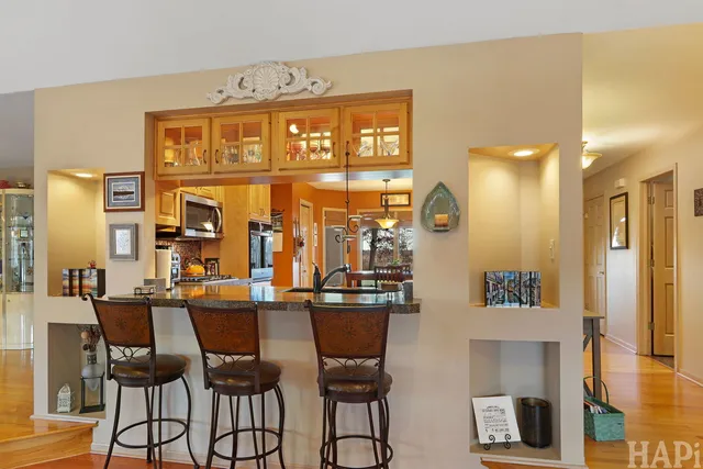 a kitchen with stainless steel appliances granite countertop a refrigerator and a sink