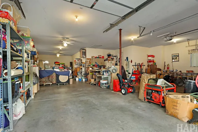 a view of a park with large trees and a wooden fence