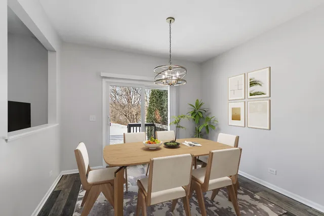 a dining room with furniture a chandelier and window