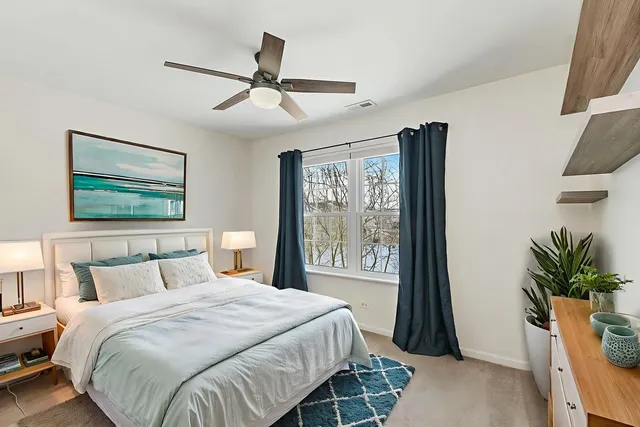 a bedroom with a large bed and a window