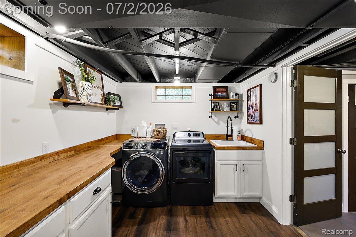 1706 Princeton Road Berkley, MI 48072 - Photo 33 of 49 Laundry area featuring wood-finish flooring, white cabinetry with wood countertops, a built-in sink with a matte black faucet, and a black painted exposed beam ceiling