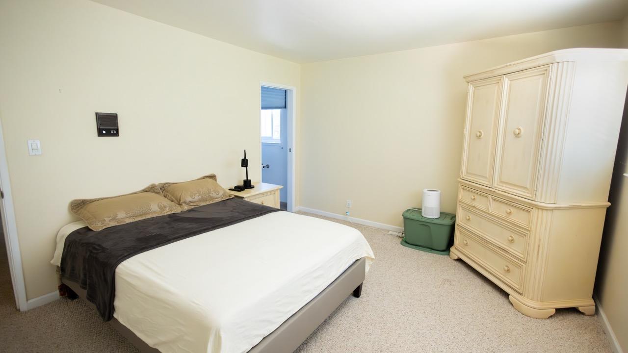 108 Stein Way Orinda, CA 94563 - Photo 30 of 40 a bedroom with a bed and a refrigerator