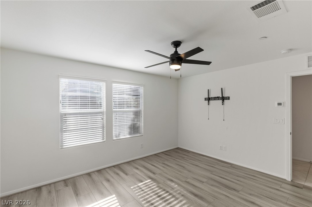 6227 Runestone Street Las Vegas, NV 89113 - Photo 6 of 33 This airy room features durable flooring and ample natural light, creating a serene and inviting atmosphere.