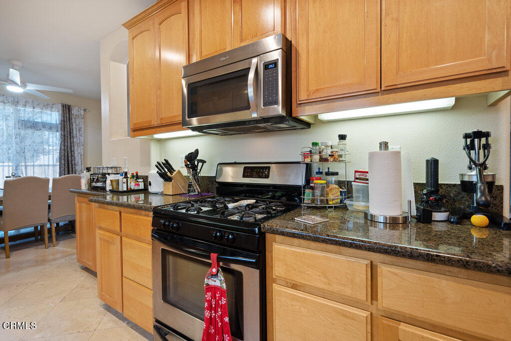 8330 Telegraph Road Downey, CA 90240 - Photo 8 of 26 a kitchen with stainless steel appliances granite countertop a stove a sink and a microwave