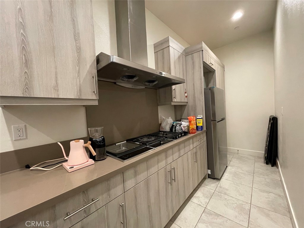 59 Dorado Irvine, CA 92618 - Photo 14 of 66 a kitchen with stainless steel appliances granite countertop a stove and a refrigerator