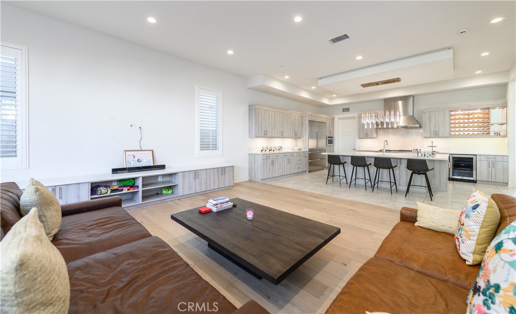 59 Dorado Irvine, CA 92618 - Photo 17 of 66 a living room with furniture a wooden floor and kitchen view