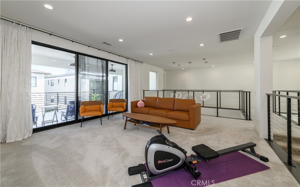 59 Dorado Irvine, CA 92618 - Photo 24 of 66 a living room with furniture gym equipment and a large window