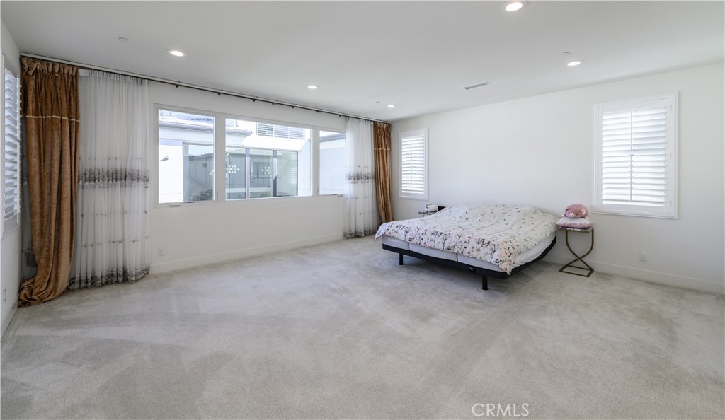59 Dorado Irvine, CA 92618 - Photo 33 of 66 a spacious bedroom with a bed and a window