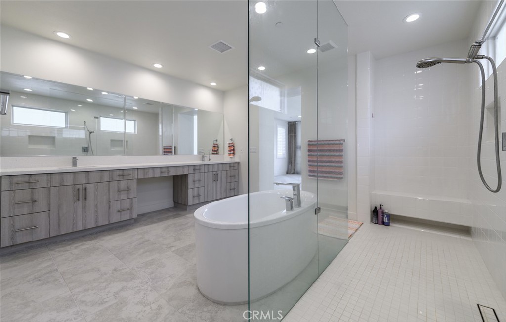 59 Dorado Irvine, CA 92618 - Photo 40 of 66 a large bathroom with a tub a sink shower and mirror