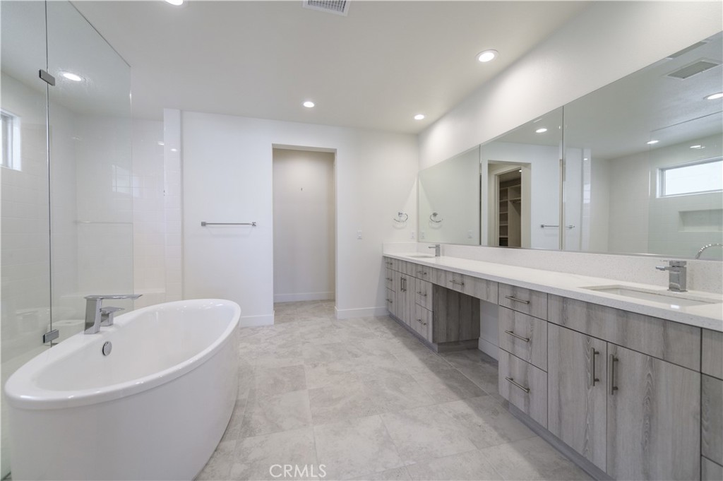 59 Dorado Irvine, CA 92618 - Photo 43 of 66 a bathroom with a double vanity sink mirror and bathtub