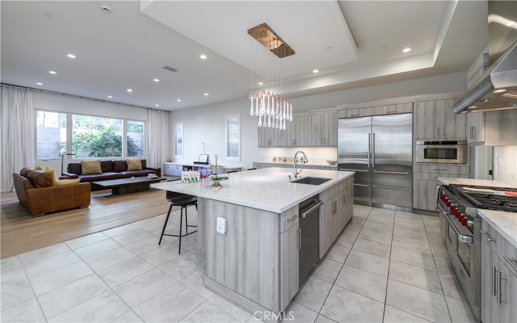 59 Dorado Irvine, CA 92618 - Photo 8 of 66 a large kitchen with kitchen island a sink a counter top stainless steel appliances and cabinets