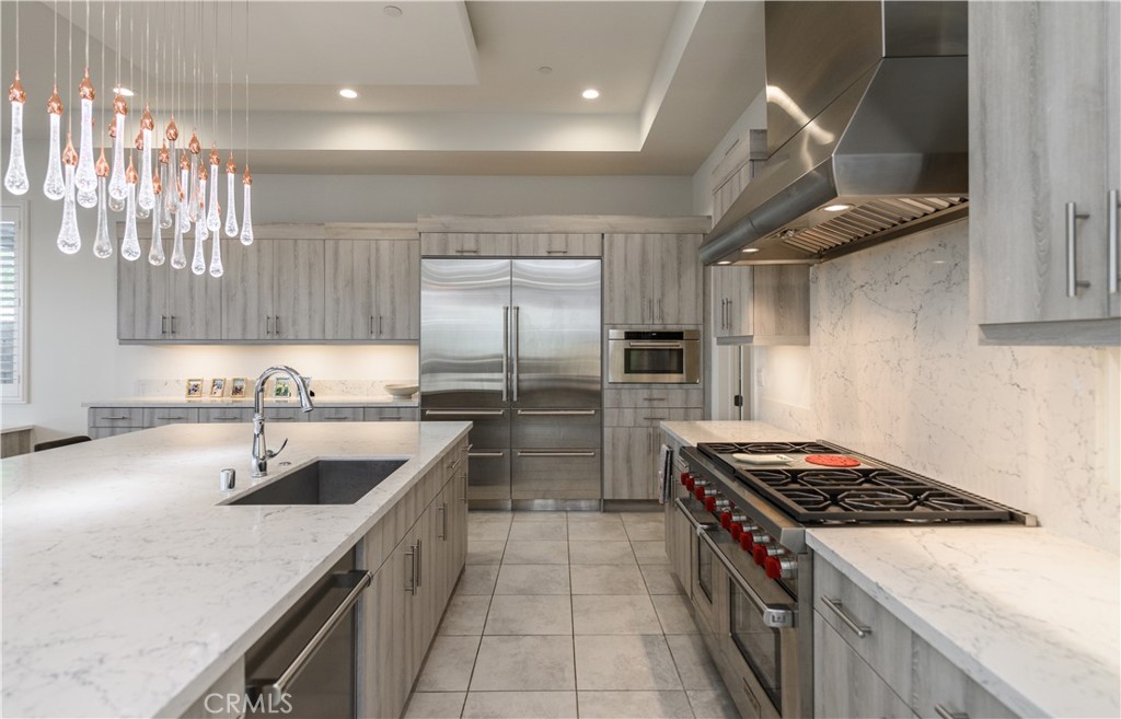 59 Dorado Irvine, CA 92618 - Photo 9 of 66 a kitchen with stainless steel appliances granite countertop a sink stove and refrigerator